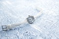 Women's watches with a white strap lie on a gray background. Royalty Free Stock Photo
