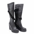 Women`s winter high boots made of black genuine leather. Royalty Free Stock Photo