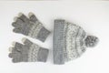 Women`s winter knitted mittens with a hat on a white background Royalty Free Stock Photo