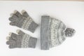 Women`s winter knitted mittens with a hat on a white background Royalty Free Stock Photo