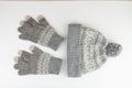 Women`s winter knitted mittens with a hat on a white background Royalty Free Stock Photo