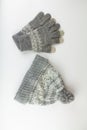 Women`s winter knitted mittens with a hat on a white background Royalty Free Stock Photo