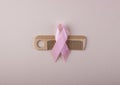Women`s wooden hairbrush and a pink ribbon, the symbol of the fight against cancer a top view
