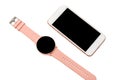 Women`s wrist smart watch with a pink strap and a smartphone on a white background. Isolated Royalty Free Stock Photo