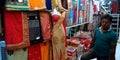 women saari center at indian street local market shopkeeper standing inside