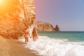 Women in Santa Claus hats run into the sea dressed in red swimsuits. Celebrating the New Year in a hot country Royalty Free Stock Photo