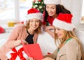 Women in santa helper hats with card and gifts Royalty Free Stock Photo