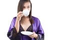 Women in satin sleepwear drinking coffee