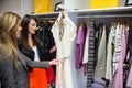 Women selecting a dress while shopping for clothes Royalty Free Stock Photo