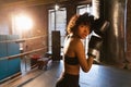 Women self defense girl power. African american woman fighter resting after fight training on boxing ring. Girl tired