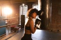 Women self defense girl power. African american woman fighter resting after fight training on boxing ring. Girl tired