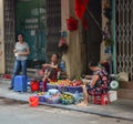 Women sell fruits on street market in Dalat, Vietnam