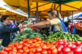 Women sell on the market ripe vegetables, onions, peppers, cucumber, greens