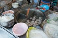 Women sell noodle on the boat at traditional floating market