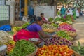 A women selling baby eggplants on the local Indian market