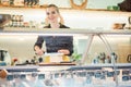 Women selling cheese at counter in a supermarket Royalty Free Stock Photo