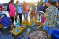 Women are selling fresh fishes at a local seafood market in Vinh Luong port