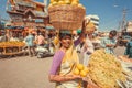 Women selling fresh fruits and oranges on outdoor market on busy asian street Royalty Free Stock Photo