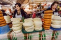 Women selling homemade and smoked cheese on big food market