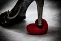 women shoes stomp on broken heart in dark tone., unrequited love