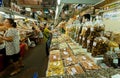 Women shopping at big market with spices, beans, fresh vegetables and exotic food