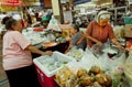 Women shopping at big market with spices, beans, fresh vegetables and exotic food