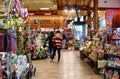 Women shopping for Christmas in a boutique western style grocery store - Brookside Reasors - with wooden beams and a fire in the Royalty Free Stock Photo