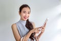 Women are shopping through mobile apps. Happy young Female holding shopping bags and mobile phone. Makes online payment on a Royalty Free Stock Photo