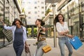 Women after shopping strolling city streets. Have fun. Royalty Free Stock Photo