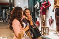 Two happy girls with shopping bags enjoying in shopping, having fun in the city Royalty Free Stock Photo