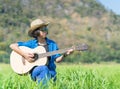 Women short hair wear hat and sunglasses sit playing guitar in g Royalty Free Stock Photo