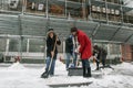 Women shovel snow