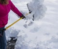 Women shoveling driveway after spring snow storm Royalty Free Stock Photo