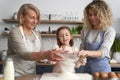 Front view of women sift the flour for Easter bake Royalty Free Stock Photo