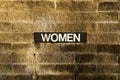 Women sign on brick wall Royalty Free Stock Photo