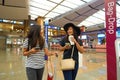 Women at Singapore Changi Airport Terminal 2 departure hall Royalty Free Stock Photo