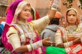 Women singers on a camel cart