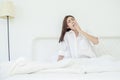 Women sit at the edge of the bed Royalty Free Stock Photo