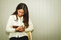 Young woman sits stressed out in front of the operating room of the hospital.