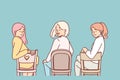 Women sitting on chairs with backs to screen turn around and look at you, during meeting Royalty Free Stock Photo