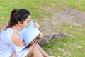 Women sitting near big tree and drawing in the park. Royalty Free Stock Photo