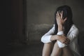 Women sitting on the floor crying with depression, Depressed woman, family problems, Stress, kitchen, abuse, Domestic violence, Royalty Free Stock Photo