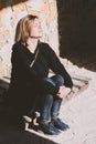 Woman sitting indoors lit by the warm rays of the sun