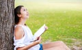 Women sitting near big tree and drawing in the park. Royalty Free Stock Photo