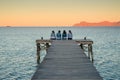 Women sitting on the pier and talk together. Mallorca, Spain. summer vacation with friends