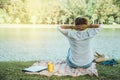 Women sitting a relax River side in the park. sitting working with a notebook and drinking coffee. in the holiday