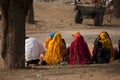 Women sitting by the roadside