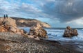 Women sitting on a rock and enjoying the beautiful stormy seascape