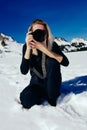 Women sitting in the snow making pictures