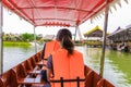 Women sitting in transport boat and wear Life jacket